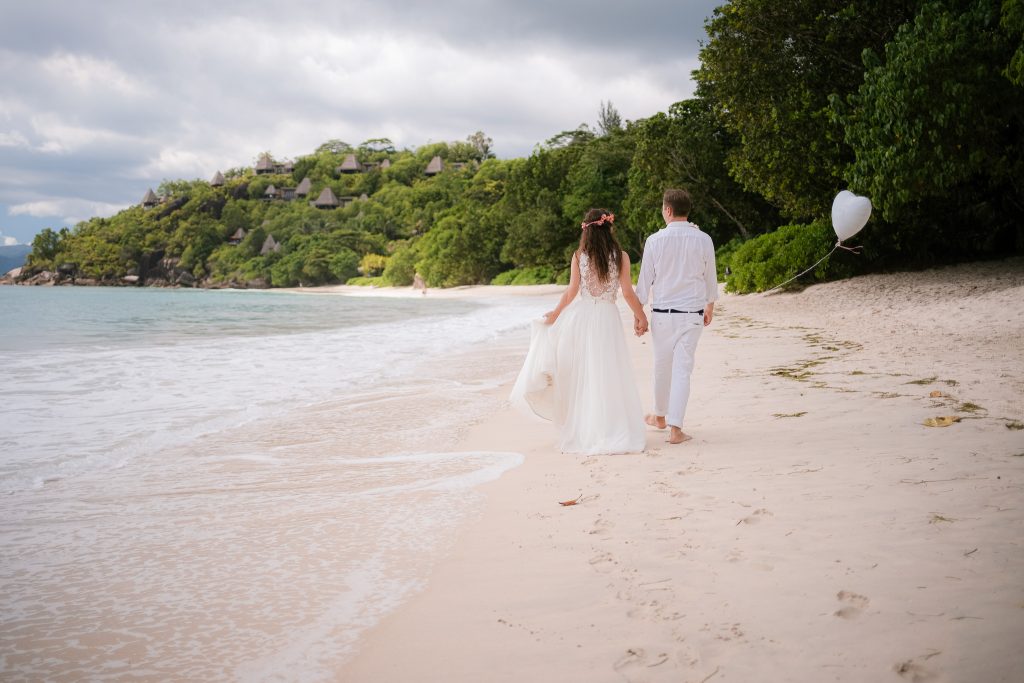 Couple walking on beach for destination weddings photographer